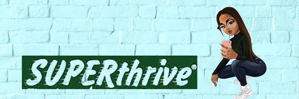 SEXY TANNED GIRL WITH GLASSES WEARING SKINNY BLUE JEANS, A BLACK SKIN TIGHT TOP, AND WHITE SNEAKERS CROUCHING DOWN TAKING A SELFIE BESIDE THE SUPERTHRIVE LOGO ON A BLUE BRICK WALL BACKGROUND